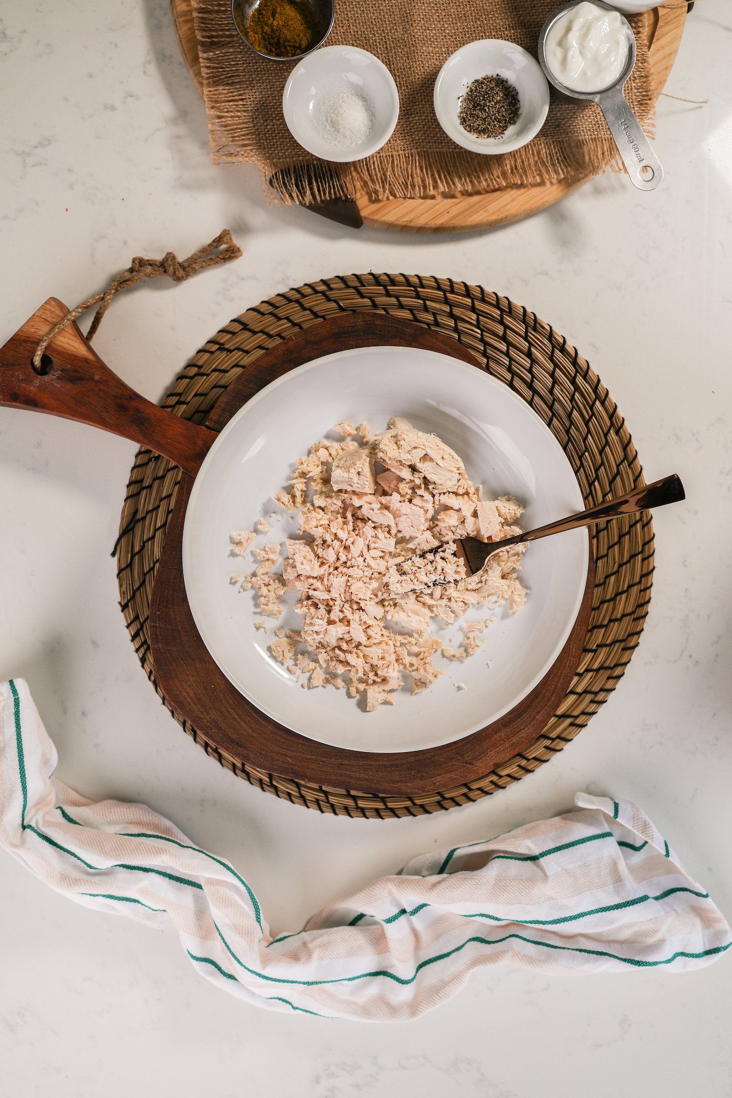 A bowl of mashed fish and a gold fork.