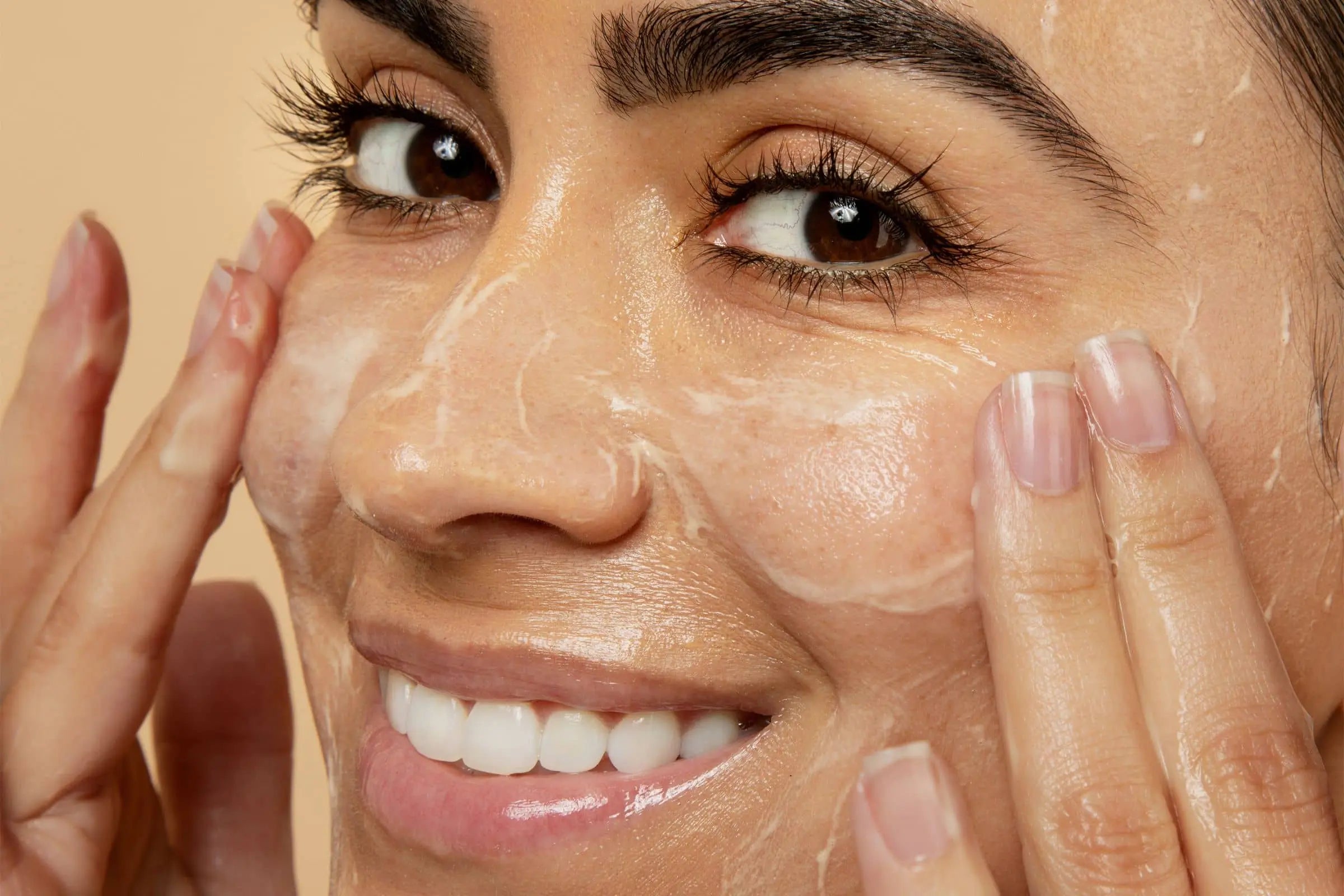 Woman washing her face with 100% PURE Products