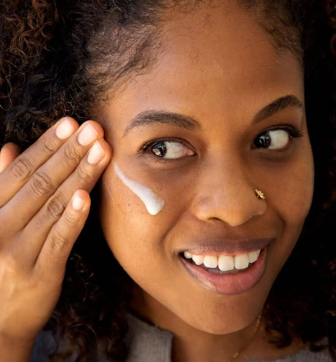 Model applying 100% PURE Retinol to her face