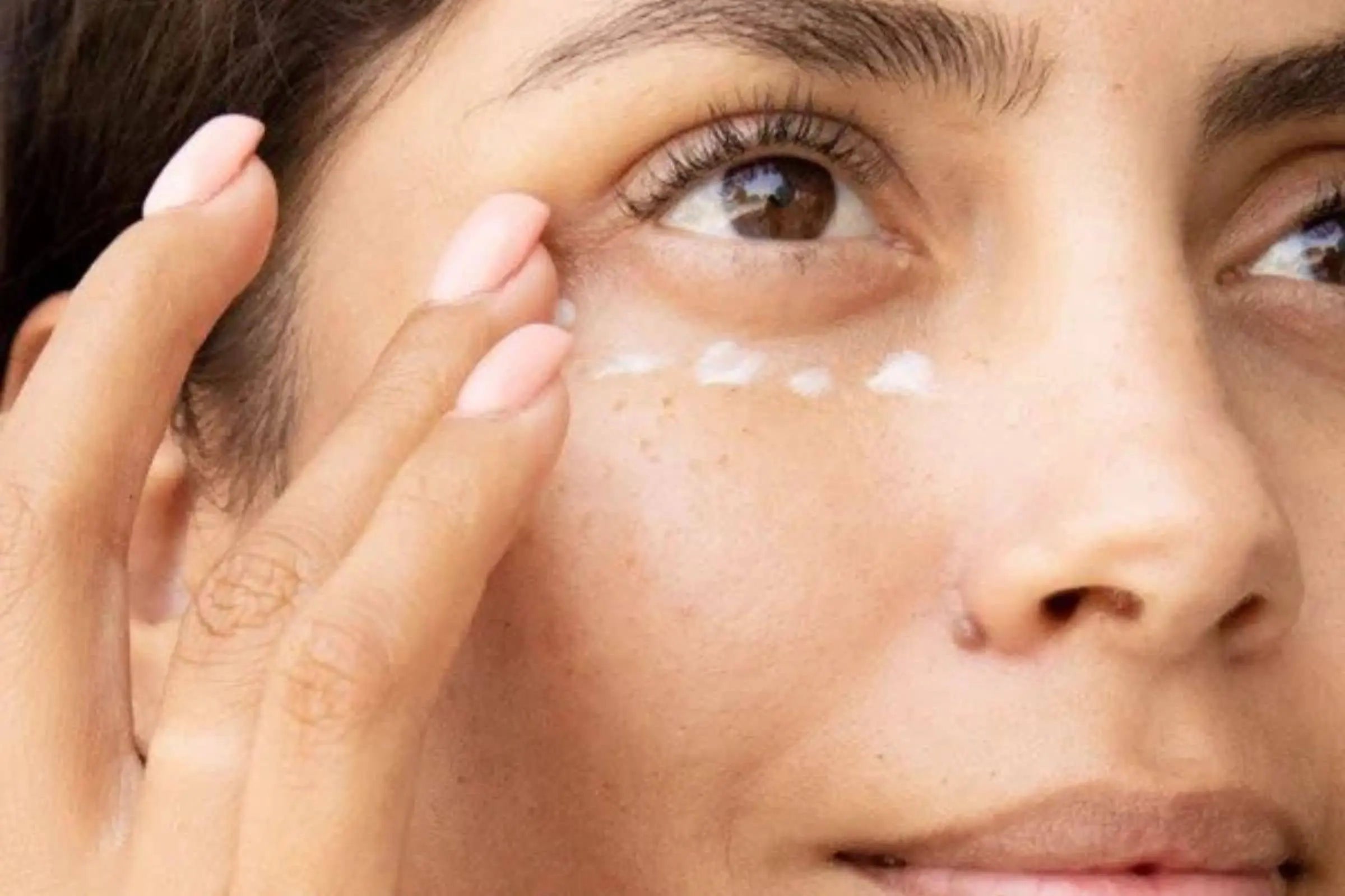 Woman using 100% PURE Coffee Bean Caffeine Eye Cream