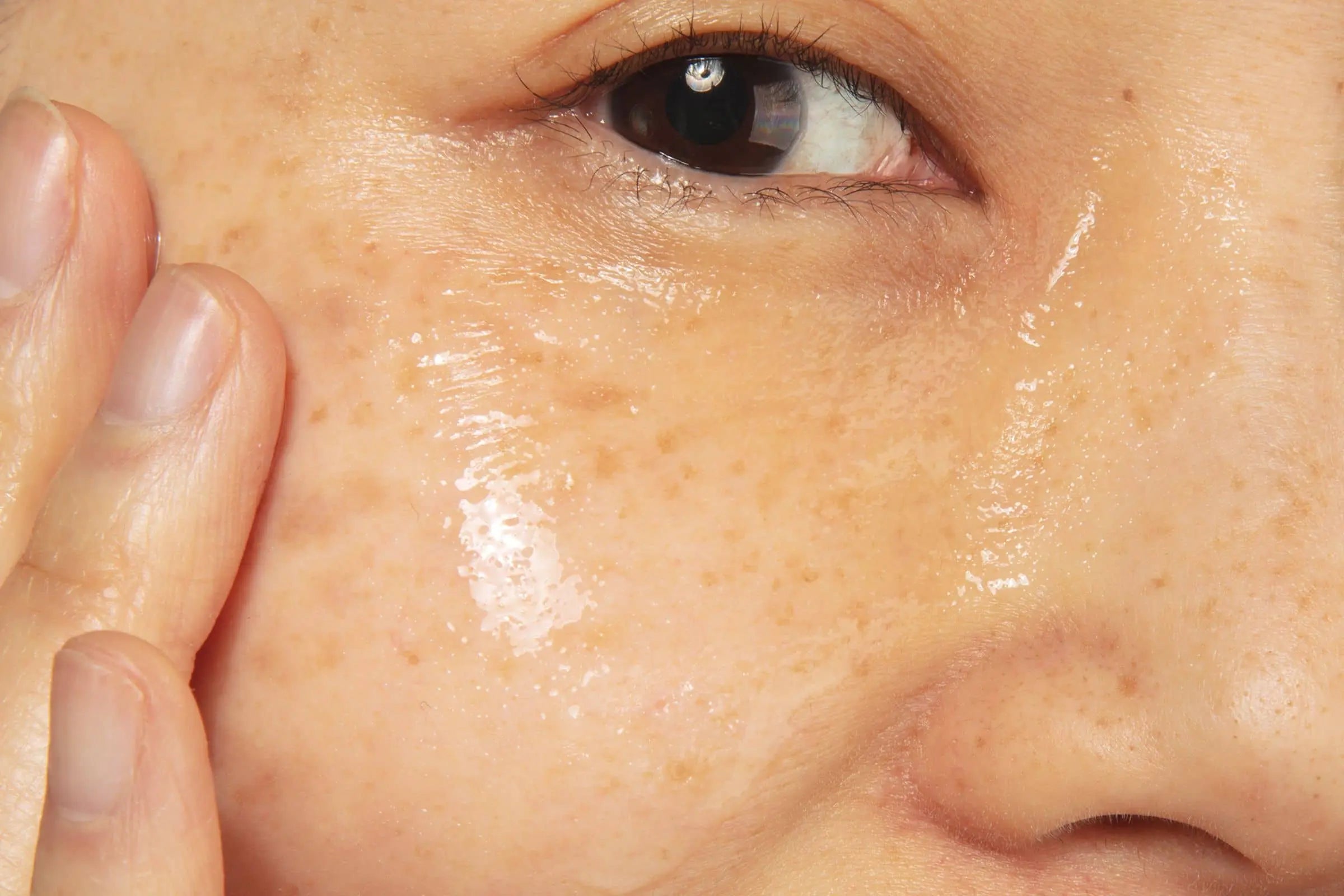 Woman using 100% PURE Rose Hyaluronic Acid for hydrated, dewy skin