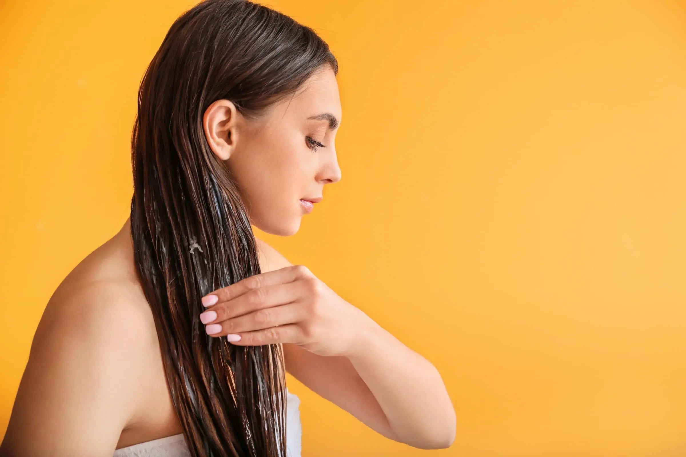 Woman applying Rosemary oil to hair