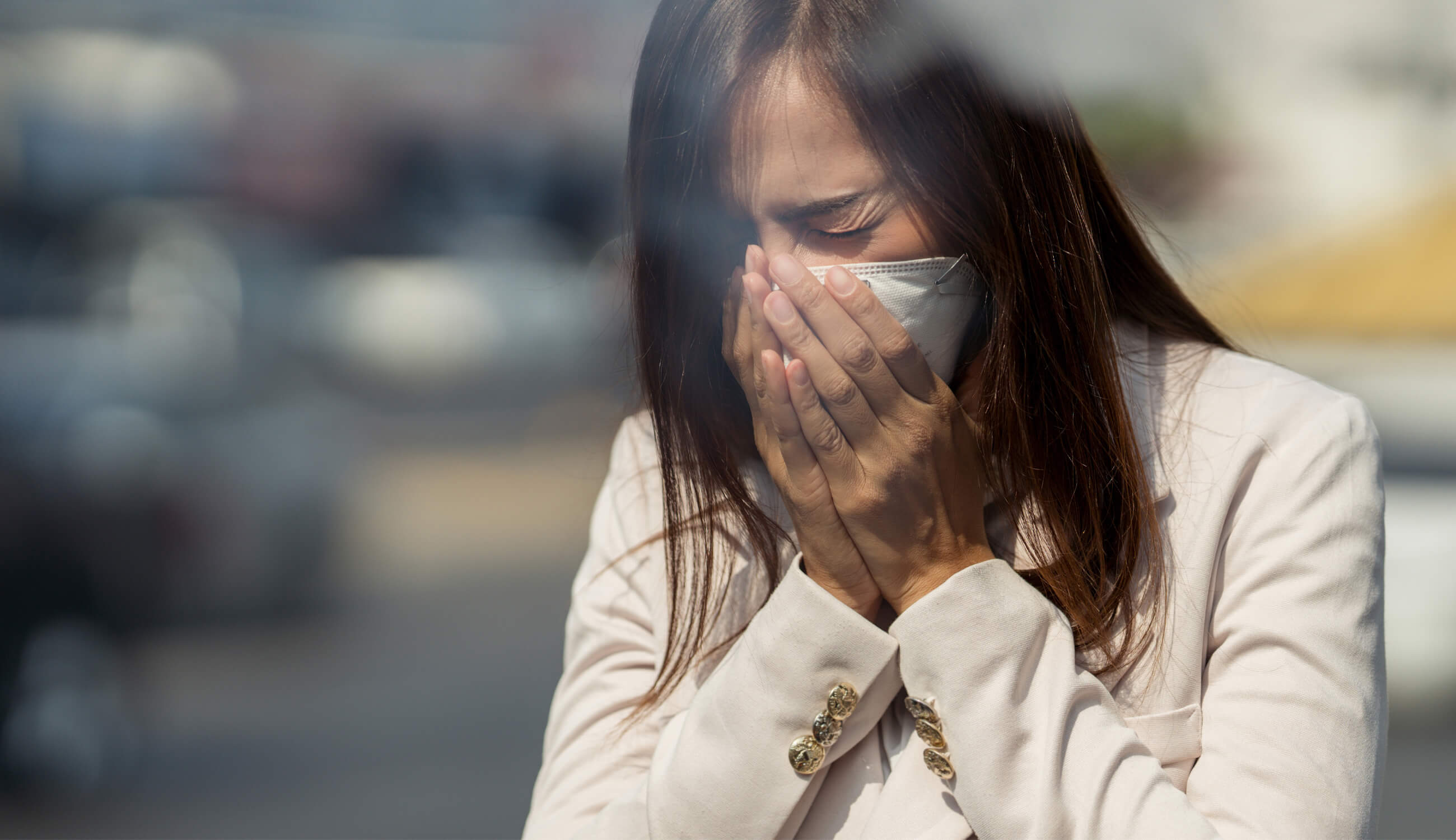 Woman outdoors with a mask on to protect from pollution