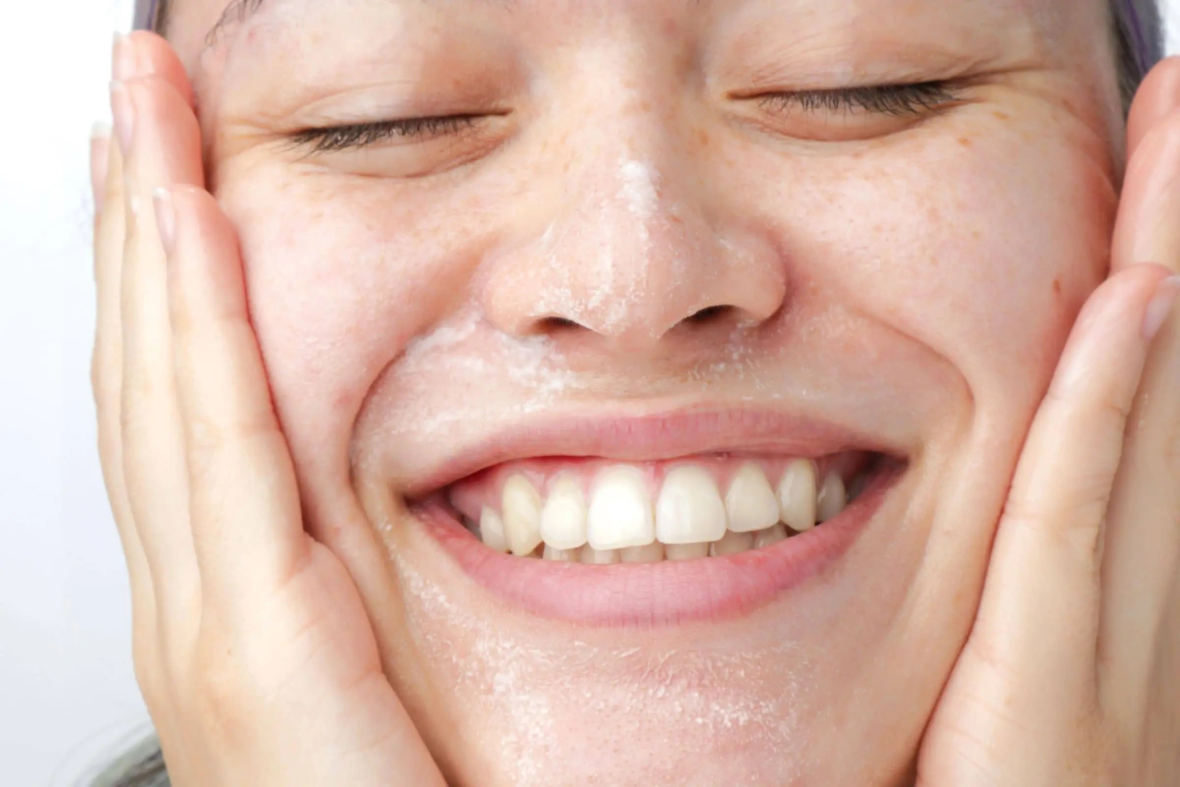 Woman using 100% PURE Rice Water Cleanser